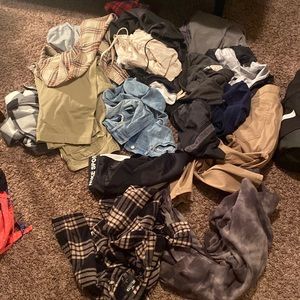 Pile of 18 men’s perfect condition clothes, sizes range from small to medium.